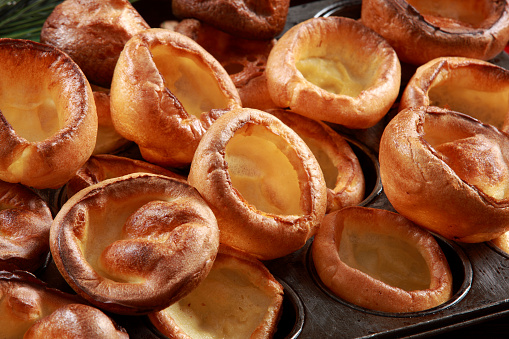 Yorkshire Pudding on Baking Tray with wood and decorative festive background